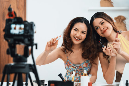 Woman influencer shoot live streaming vlog video review makeup uttermost social media or blog. Happy young girl with cosmetics studio lighting for marketing recording session broadcasting online.の写真素材