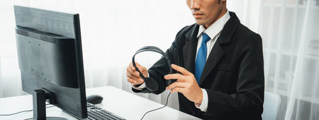 Business people wearing headset working in office to support remote customer or colleague. Call center, telemarketing, customer support agent provide service on telephone video conference oratory callの写真素材