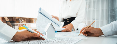 Worker, architect and engineer work on real estate construction project oratory planning with...