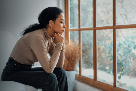 Depressed young Black woman with mental health problem in mind need crucial treatment from overthinking fatigue girl, disruptive thought, dissocial, anxiety and other mental health disorders .の写真素材