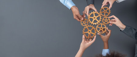 Panoramic shot top view of business people holding cog wheel as unity and teamwork in corporate...