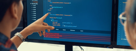 Female programer explain while pointing code displayed on computer. Professional programmer present...