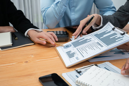 Multiracial analyst team use BI dashboard data to analyze financial report on meeting table. Group...