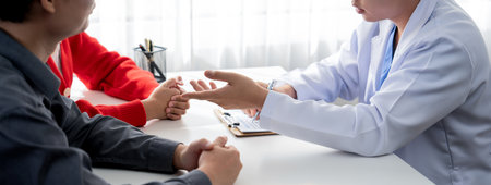 Couple attend fertility consultation with gynecologist at hospital as part family planning care for...