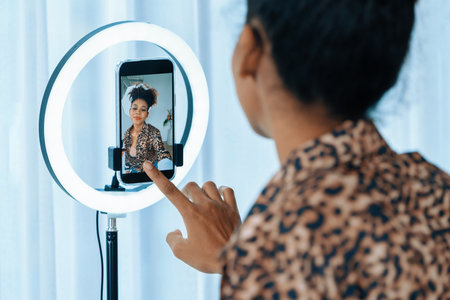 Woman influencer shoot live streaming vlog video review clothes crucial social media or blog. Happy...
