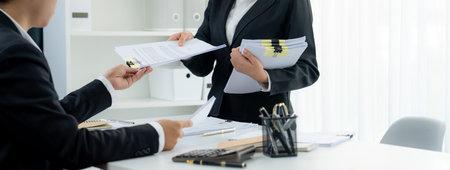Corporate accountant team use calculator to calculate and maximize tax refunds and improve financial...