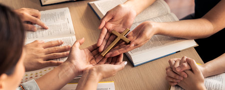Close-up women prayer deliver holy bible book and holy cross to believer group. Spreading religion symbol. Concept of hope, religion, christianity and god blessing. Warm background. Burgeoning.の写真素材