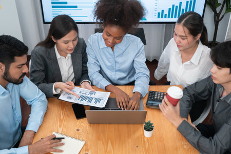 Multiracial analyst team use BI dashboard data to analyze financial report on meeting table. Group of diverse business people utilize data analysis by FIntech for success business marketing. Concordの写真素材