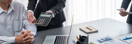 Auditor and accountant team working in office, analyze financial data and accounting record with calculator. Accounting company provide finance and taxation planning for profitable cash flow. Insightの写真素材