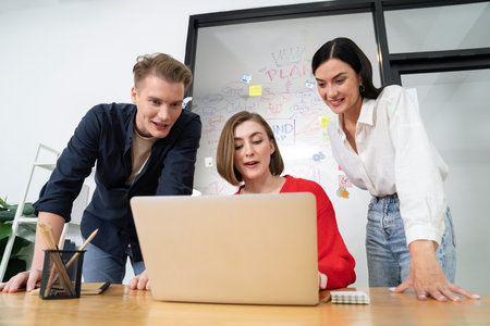 Professional business team working together by using laptop in start up project at meeting in front of glass board with mind map while colleague brainstorm and discuss about strategy. Immaculate.の写真素材