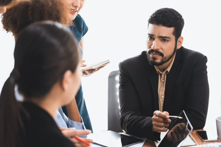Happy diverse business people work together, discussing in corporate office. Professional and diversity teamwork discuss business plan on desk with laptop. Modern multicultural office worker. Concordの写真素材