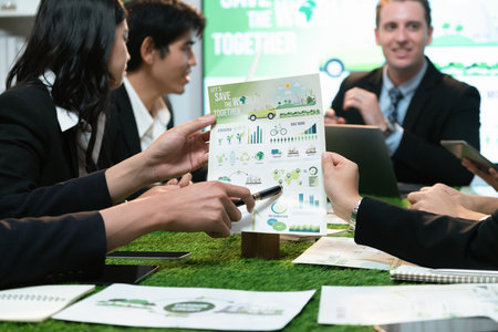 Diverse group of business people planning business marketing with environmental responsibility for greener ecology. Productive teamwork contribute natural preservation and sustainable future. Quaintの写真素材