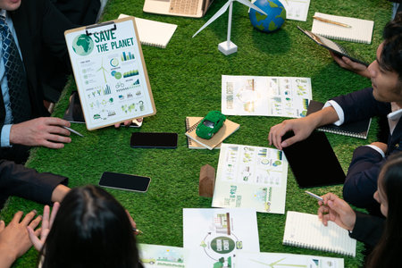 Diverse group of business people planning for alternative energy utilization for greener sustainable Earth by reducing CO2 emission and carbon credit with renewable clean energy technology. Quaintの写真素材