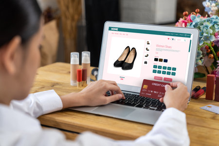 Woman shopping online on internet marketplace browsing for sale items for modern lifestyle and use credit card for online payment from wallet protected by uttermost cyber security softwareの写真素材