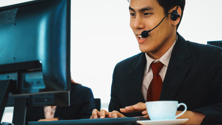 Business people wearing headset working in office to support remote customer or colleague. Call center, telemarketing, customer support agent provide service on telephone video conference call. Jivyの写真素材