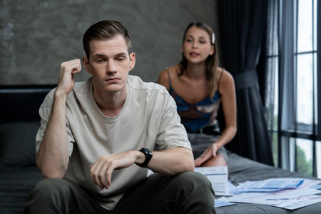 Stress young family couple worried about overwhelming and massive credit card bill or final mortgage loan notification. Modern family financial crisis from over spending online shopping. Unveilingの写真素材