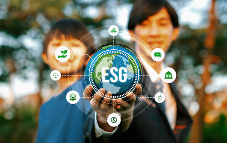 Focus planet Earth globe with eco friendly icon hold by blur businessman and little boy. Green business invest in environmental protection by ESG sustainable technology for future generation. Relianceの写真素材