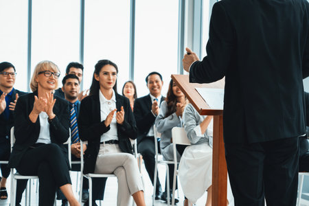 Group of business people meeting in a seminar conference . Audience listening to instructor in employee education training session . Office worker community summit forum with expert speaker . Jivyの写真素材