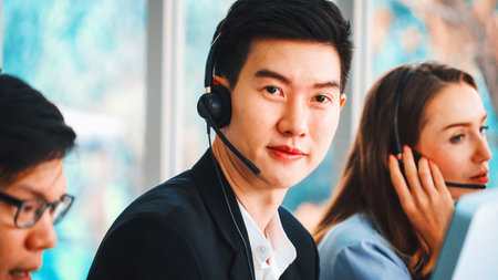 Business people wearing headset working in office to support remote customer or colleague. Call center, telemarketing, customer support agent provide service on telephone video conference call. Jivyの写真素材