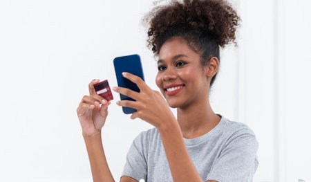 Young happy woman buy product by online shopping at home while ordering items from the internet with...