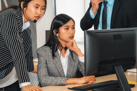 Business people wearing headset working in office to support remote customer or colleague. Call center, telemarketing, customer support agent provide service on telephone video conference call. Jivyの写真素材
