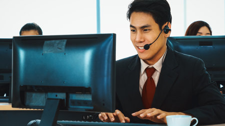 Business people wearing headset working in office to support remote customer or colleague. Call center, telemarketing, customer support agent provide service on telephone video conference call. Jivyの写真素材