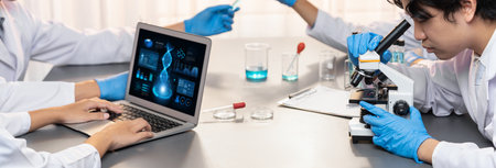 Dedicated scientist group working on advance biotechnology computer software to study or analyze DNA data after making scientific breakthrough from chemical experiment on medical laboratory. Neotericの写真素材