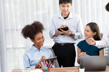 Happy diverse business people work together, discussing in corporate office. Professional and...