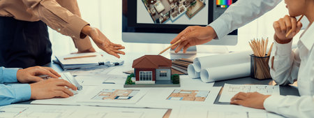 Group of interior architect designer discussing together on blueprint and laptop screen display architecture software for more precise designing layout. Modern home design and renovation. Insightの写真素材
