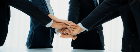 Office worker team stacking hand together symbolize successful group of business partnership and...