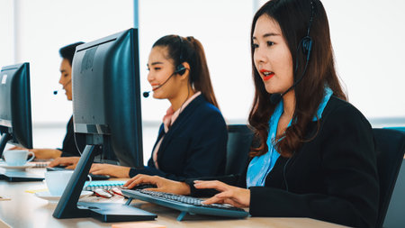 Business people wearing headset working in office to support remote customer or colleague. Call center, telemarketing, customer support agent provide service on telephone video conference call. Jivyの写真素材