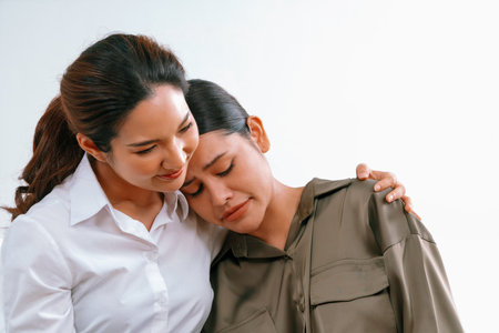 Sad PTSD woman patient in uttermost therapy for mental health with psychologist, depression or grief after life failure. Frustrated trauma young woman talking to a psychologist about emotion in officeの写真素材