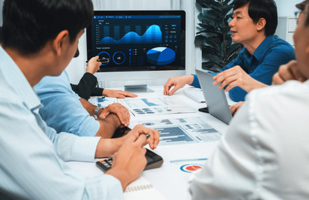 Analyst team utilizing BI Fintech to analyze financial data at table in meeting room. Businesspeople...