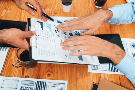 Top view diverse group of business analyst team analyzing financial data report paper on meeting table. Chart and graph dashboard by business intelligence analysis. Habilimentの写真素材