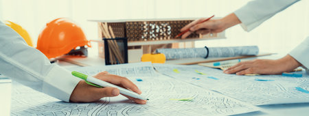 Worker, architect and engineer work on real estate construction project oratory planning with...