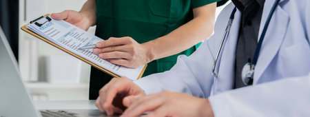 Professional various team of medical working and planning medical treatment at hospital table...