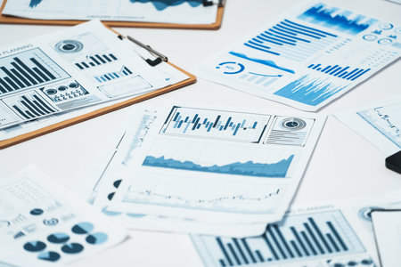 Piles of business intelligence paper or BI financial report and financial data visualization on...