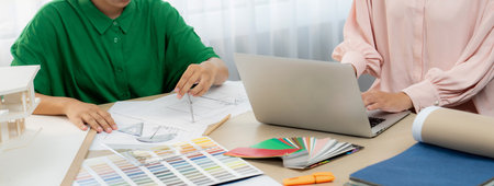 Skilled interior designer using architectural equipment draw a blueprint while interior designer...