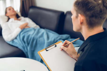 Stressed and depressed patient seeking help from psychiatrist with mental illness and depression in office during mental therapy session. Mental health treatment and medical care concept. Unveilingの写真素材