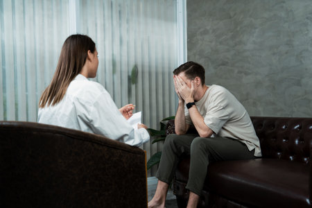 Stressed and depressed patient seeking help from psychiatrist with mental illness and depression in...