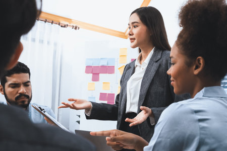 Young asian businesswoman presenting data analysis dashboard on TV screen in modern meeting. Business presentation with group of business people in conference room. Concordの写真素材