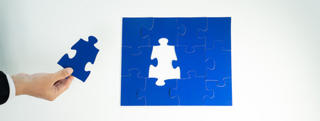 Panorama banner of business team assembling jigsaw puzzle over table symbolize business partnership...