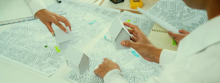 Worker, architect and engineer work on real estate construction project oratory planning with...
