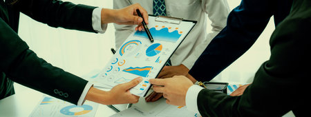 Business people in group meeting in formal attire share idea discussing report for company profit in...