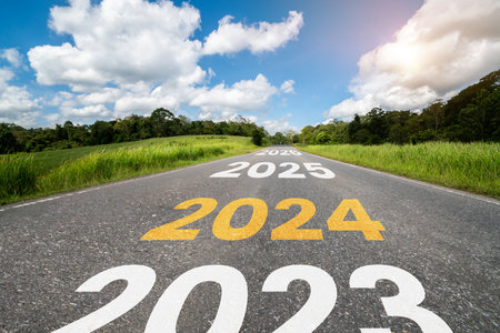 2024 New Year road trip travel and future vision concept . Nature landscape with highway road leading forward to happy new year celebration in the beginning of 2024 for bliss and successful start .の写真素材