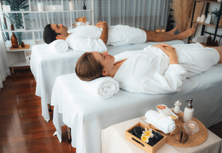 Caucasian couple customer enjoying relaxing anti-stress spa massage and pampering with beauty skin recreation leisure in day light ambient salon spa at luxury resort or hotel. Quiescentの写真素材