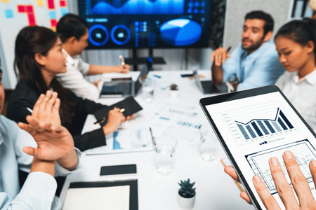 Analyst team uses BI Fintech display tablet to analyze financial data . Business people analyze BI software technology dashboard power for insights power into business marketing planning. Prudentの写真素材