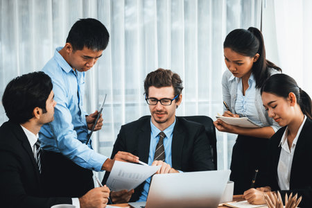Diverse of business people from various ethnic group working in modern office environment. Productive and multi ethnic office workers engage in discussion for strategic business marketing. Meticulousの写真素材