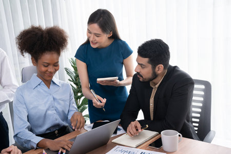 Happy diverse business people work together, discussing in corporate office. Professional and...