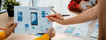 Panorama banner of startup company employee planning on user interface prototype for mobile application or website in office. UX UI designer brainstorm user friendly interface plan. Synergicの写真素材
